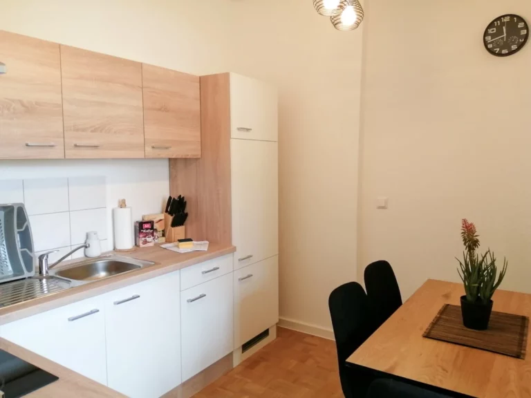 Apartment Südstadt Küche mit Esstisch und Stühlen.